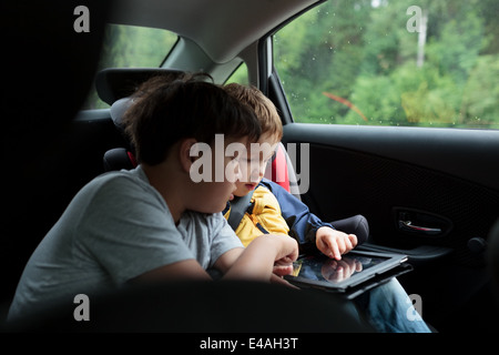 Boys in the car using a touchpad Stock Photo