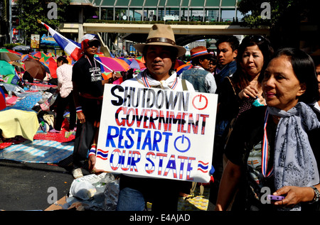 BANGKOK, THAILAND: Thai protestor holding political sign during Day 2 of Operation Shut Down Bangkok on 14 January 2014 Stock Photo