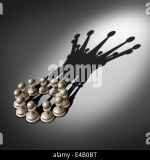 Leadership team and business group concept as an organized company of chess pawn pieces joining forces and working together united and as one in agreement to cast a shadow shaped as the crown of a king. Stock Photo