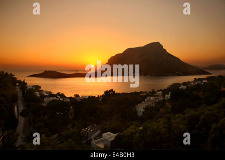 Sun setting behind Telendos island. Photo taken at Kalymnos island, Dodecanese, Aegean sea, Greece Stock Photo