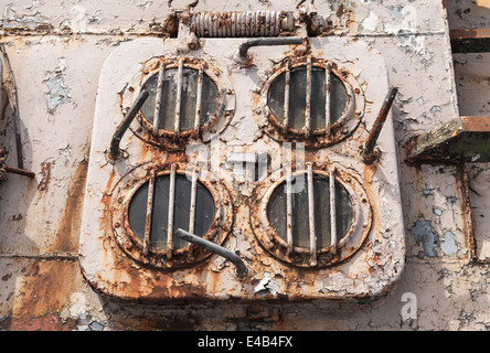 Old grungy emergency exit hatch on the deck of abandoned ship Stock Photo