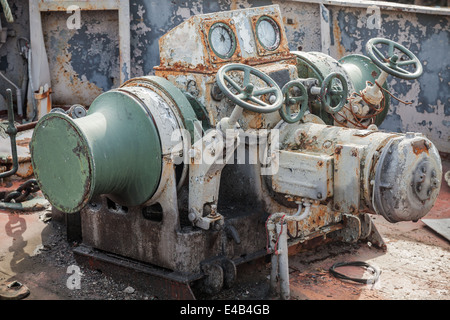 Rusted bow anchor winch on abandoned ship Stock Photo