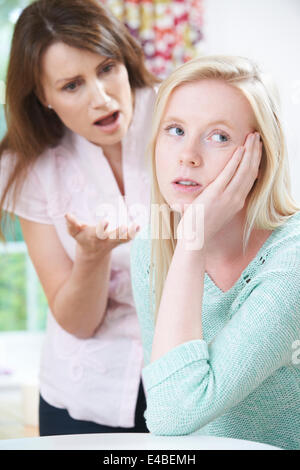 Mother Telling Off Teenage Daughter At Home Stock Photo