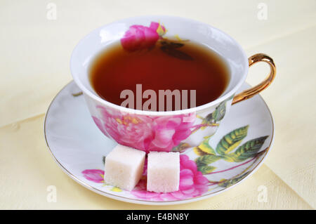 A cup of tea and sugar in isolation on a white background Stock Photo