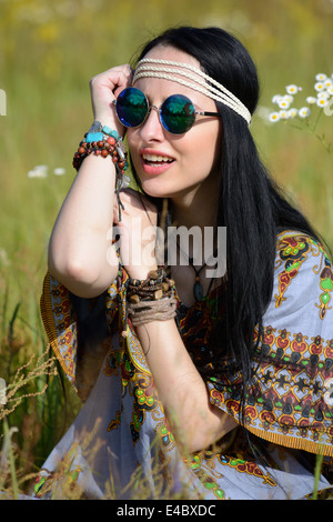 hippie girl on a flowering field Stock Photo