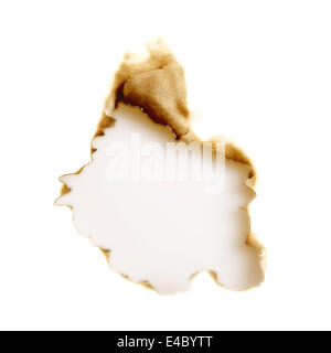 burnt hole in a white sheet of paper Stock Photo