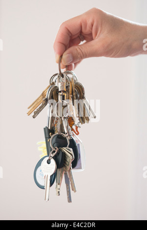 Hand holding large bunch of keys Stock Photo
