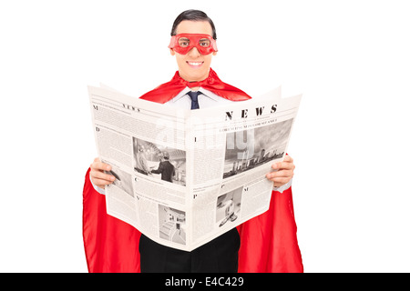 Masked superhero reading the news Stock Photo