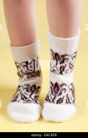 feet socks knitted woolen wool warm pattern ornament clothing needlework knitting white yellow baby standing llama merino winter Stock Photo