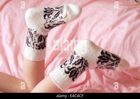 feet socks knitted woolen wool warm white pattern ornament clothing needlework knitting baby lying winter children's llama merin Stock Photo