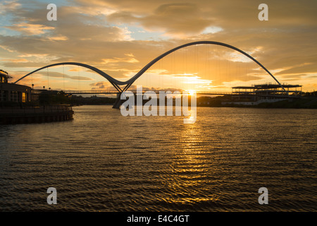 Sunset, Infinity Bridge that gives a pedestrian and cycle link from Thornaby on Tees to the Portrack area of Stock ton on Tees Stock Photo