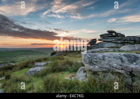 Beautiful sunset over a granite tor at the Cheesewring on Stowes Hill near the Minions on Bodmin Moor in Cornwall Stock Photo