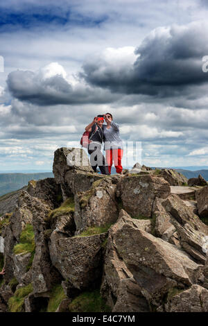 Two young ladies on Striding Edge taking self portraits of themselves ... "selfies" Stock Photo