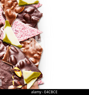 Assorted chocolate pieces border on white background Stock Photo