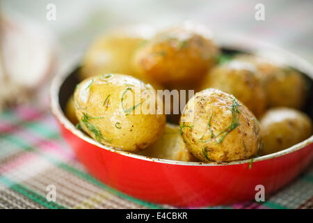 roasted new potatoes in a pan on the table Stock Photo