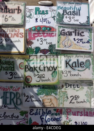 A sign advertising a selection of organic and non-organic vegetables for sale in the Union Square Greenmarket in New York Stock Photo