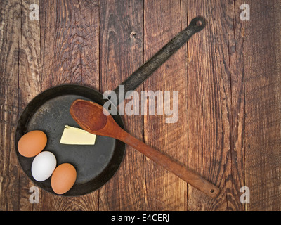 vintage set for frying eggs over wooden table, space for your text Stock Photo