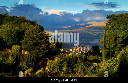 View over the mountains of Snowdonia in North Wales UK with Conwy Castle visible in the distance Stock Photo
