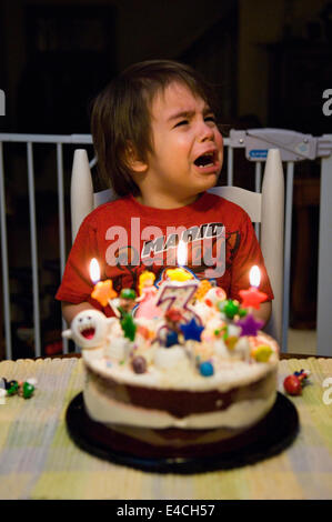 Three Year Old Boy Crying While Celebrating his Birthday Stock Photo