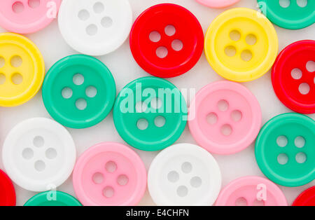 Various color buttons on a white paper background Stock Photo