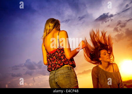 Two young women enjoying the sunset, Osijek, Croatia Stock Photo