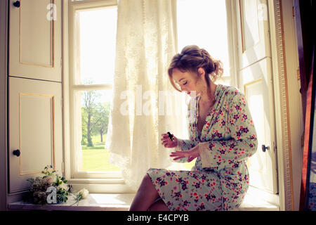 Wedding preparations, Woman painting fingernails, Dorset, England Stock Photo