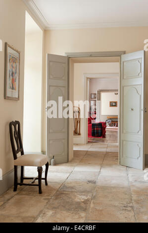 French antique dining chair in stone floored hallway Stock Photo