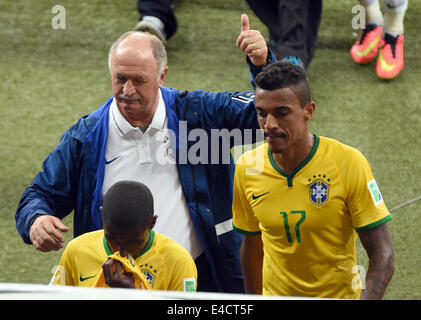 Belo Horizonte, Brazil. 08th July, 2014. Brazil's coach Luiz Felipe Scolari and player Luiz Gustavo leave the pitch after the FIFA World Cup 2014 semi-final soccer match between Brazil and Germany at Estadio Mineirao in Belo Horizonte, Brazil, 08 July 2014. Photo: Andreas Gebert/dpa/Alamy Live News Stock Photo