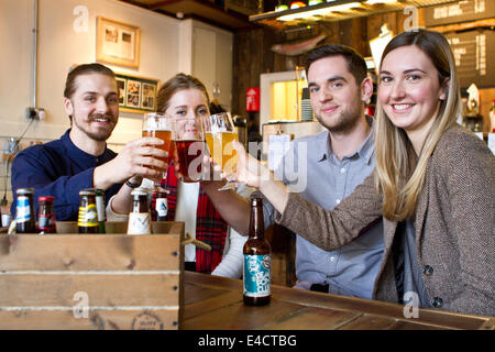 Friends toasting with beer in pub, Dorset, Bournemouth, England Stock Photo