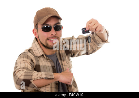 happy young guy in flannel shirt and cap showing car keys Stock Photo