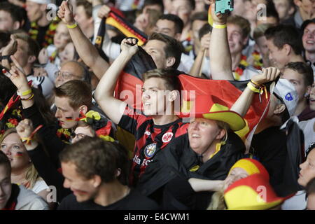 The German fans celebrate when their team have goal. Thousands of fans watched the 2014 FIFA Soccer World Cup Semi Final between host Brazil and Germany in Frankfurt's Commerzbank-Arena in the Europe's largest World Cup Screen (412 squaremeters) and in the match, Germany beat Brazil by 7 to 1. Stock Photo