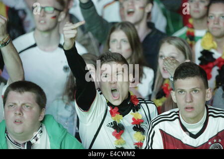 The German fans celebrate when their team have goal. Thousands of fans watched the 2014 FIFA Soccer World Cup Semi Final between host Brazil and Germany in Frankfurt's Commerzbank-Arena in the Europe's largest World Cup Screen (412 squaremeters) and in the match, Germany beat Brazil by 7 to 1. Stock Photo