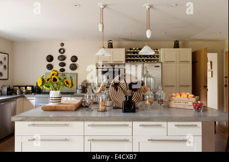 Concrete worktops in a kitchen with French pendant lights Stock Photo