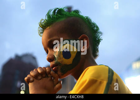 Sao Paulo. 08th July, 2014. A Brazil's fan reacts while watching a semifinal match between Brazil and Germany of 2014 FIFA World Cup at the FIFA Fan Fest area in Sao Paulo, Brazil, on july 08, 2014. Credit:  Rahel Patrasso/Xinhua/Alamy Live News Stock Photo