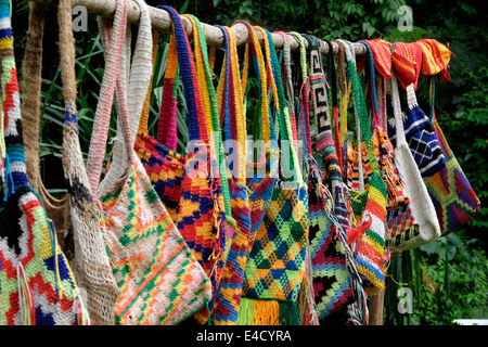 A selection of colourful hand made bags called bilums on display in Papua New Guinea Stock Photo
