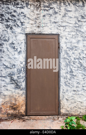 Rough Concrete Wall with Wood Door. Stock Photo