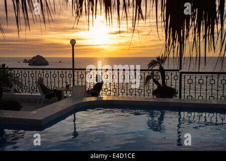 A couple enjoys the sunset from the top floor of the Freeman Hotel in Mazatlan, Sinaloa, Mexico. Stock Photo