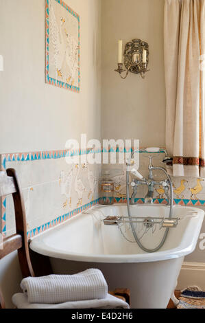 Freestanding bath in bathroom with goose tile work. Stock Photo