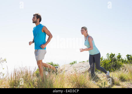 Fit couple jogging on a country trail Stock Photo