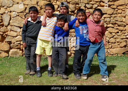 Group of children standing in front of the ruins of Viracochapampa near Huamancuco, Peru Stock Photo