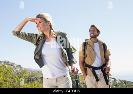 Attractive hiking couple walking on mountain trail Stock Photo
