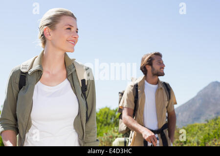 Attractive hiking couple walking on mountain trail Stock Photo