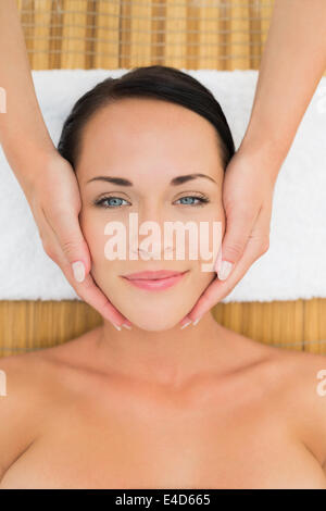 Peaceful brunette enjoying a facial massage Stock Photo