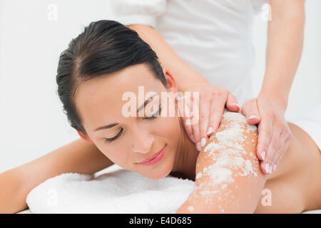Peaceful brunette getting a salt scrub beauty treatment Stock Photo