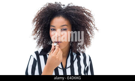 Pretty referee blowing her whistle Stock Photo