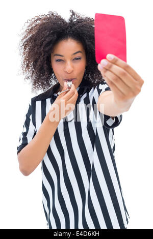 Pretty referee blowing her whistle and showing red card Stock Photo