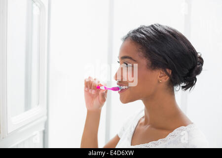 Pretty woman brushing her teeth Stock Photo