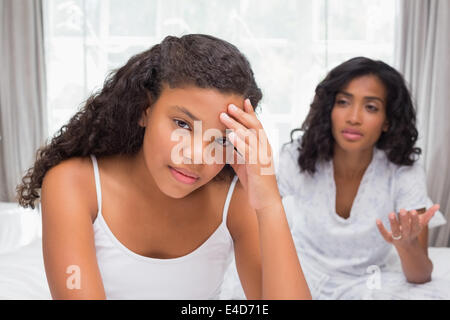 Mother and daughter having an argument on bed Stock Photo