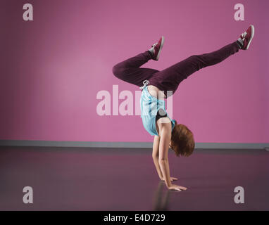Pretty break dancer doing a handstand Stock Photo