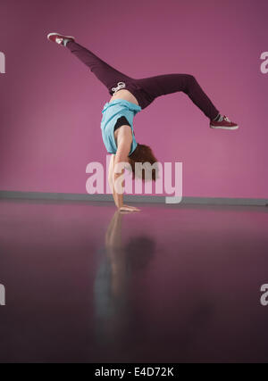 Pretty break dancer doing handstand Stock Photo